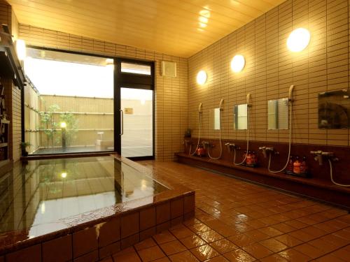 a bathroom with mirrors and sinks in a room at Oyado Yamakyu in Takayama