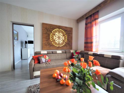 a living room with a couch and a table at VIP Apartamenty KRUPÓWKI in Zakopane