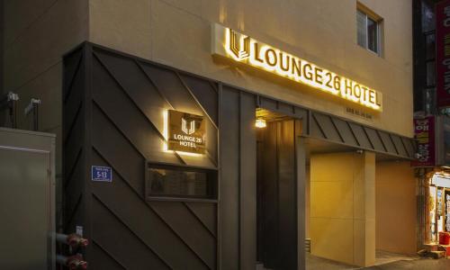 a building with a sign for a luxury hotel at Busan Lounge 26 Hotel in Busan