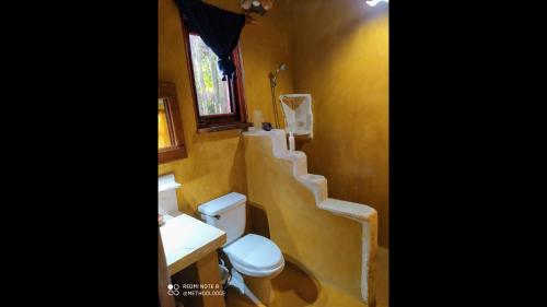 a bathroom with a toilet and a sink and stairs at Method Living Tropical Edition 50024 in Cabarete