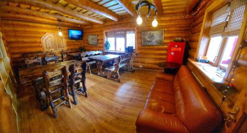 a living room with a couch and a table in a cabin at Дерев'яний котедж "Казка" in Yaremche