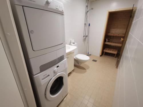 a bathroom with a washer and dryer in it at 2-Bedroom Royal Apartment with Own Sauna in Kotka in Kotka