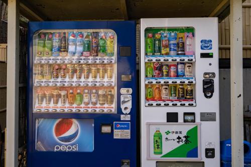 a vending machine filled with lots of bottles of soda at Tabist Kinugawa Park Cottage in Nikko