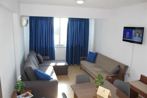 a living room with a couch and a table at Maria Zintili Apartments in Ayia Napa