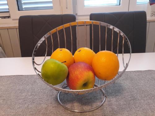 a bowl of fruit sitting on a table at apartman-maja-krk in Krk