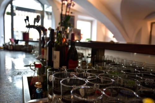 a bunch of wine glasses sitting on a bar at Hotel Krone in Brunico