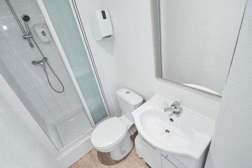 a bathroom with a toilet and a sink and a shower at Premiere Classe Cergy Saint Christophe in Cergy