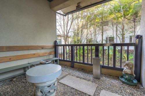 a porch with a toilet sitting on a balcony at Tabist Kinugawa Park Cottage in Nikko