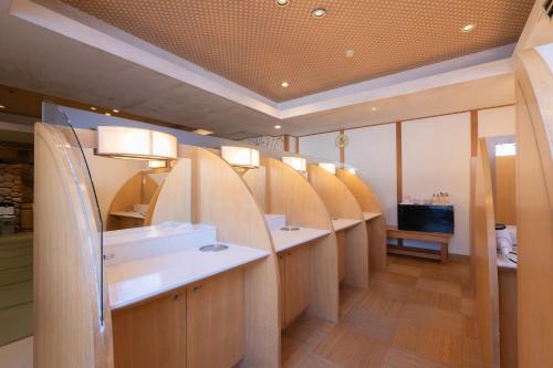 a bathroom with a row of sinks and mirrors at Tabist Kinugawa Park Cottage in Nikko