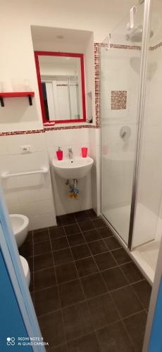 a bathroom with a sink and a shower and a toilet at Casa Cristina in Siracusa