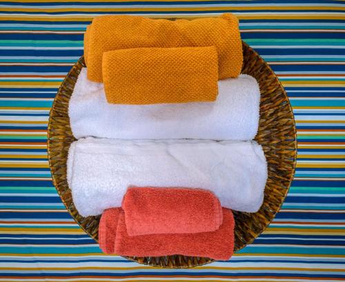 a basket filled with different colored towels on a table at Aduepassi in Ascoli Piceno