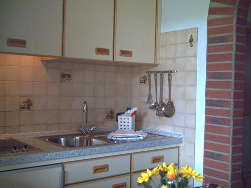a kitchen with a sink and a counter top at Haus-Nordseemelodie-Wohnung-4 in Wittdün