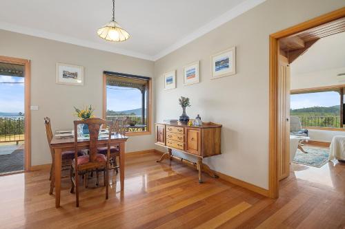 a dining room with a desk and a table with a chair at Manfield Country Bruny Island in Alonnah
