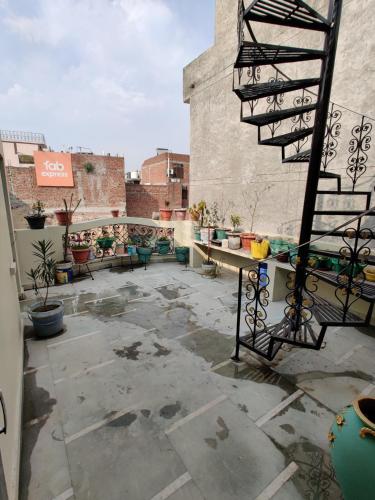 a patio with a spiral staircase on top of a building at Vrinda Apartments in Amritsar