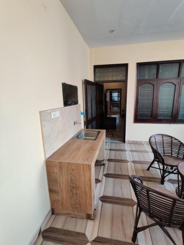 a room with two chairs and a wooden counter at Vrinda Apartments in Amritsar