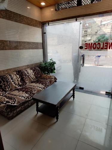 a living room with a couch and a coffee table at Vrinda Apartments in Amritsar