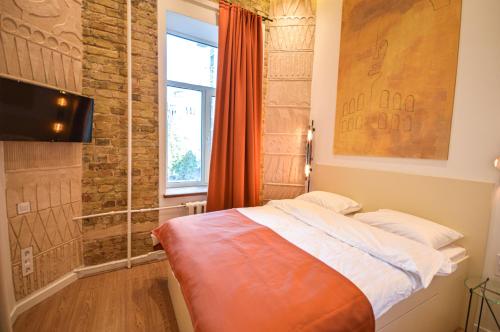 a small bedroom with a bed and a window at Kyiv Whisky Box Apart-Hotel in Kyiv