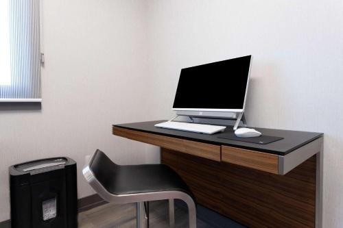 a desk with a laptop computer on top of it at Travelodge by Wyndham Elkhart in Elkhart