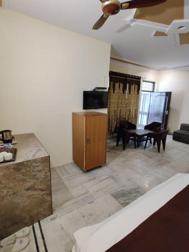 a living room with a couch and a table at Vrinda Apartments in Amritsar