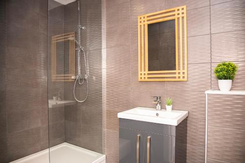 a bathroom with a shower and a sink and a toilet at Lord Street Apartments By Happy Days in Liverpool