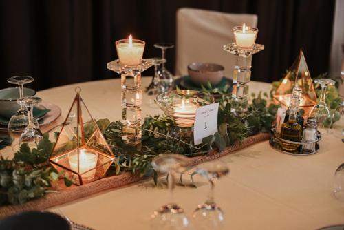 a table with candles and other items on it at Royal Airport Hotel in Velika Gorica