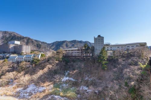 a group of buildings on top of a hill at Tabist Kinugawa Park Cottage in Nikko