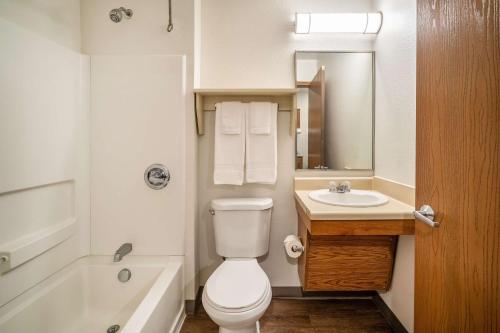 a bathroom with a white toilet and a sink at WoodSpring Suites Corpus Christi in Corpus Christi