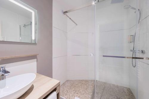 a bathroom with a shower and a sink at Hotel Le Circuit Le Mans in Le Mans