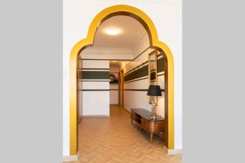 a hallway with an archway with a table and a lamp at Royal Residence Maiden Tower in Istanbul