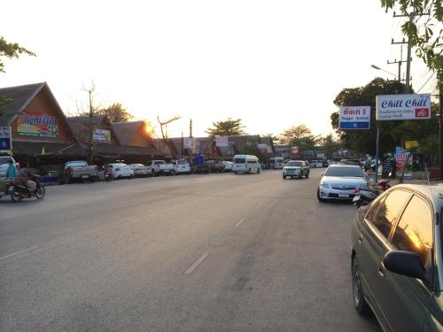 a street with cars parked on the side of the road at Rock Garden E28 Pool villa in Mae Pim