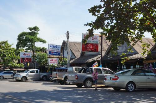 a group of cars parked on a street with signs at Rock Garden E28 Pool villa in Mae Pim