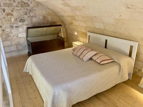 a bedroom with a bed with two pillows on it at Musciu ti Lammia in Manduria