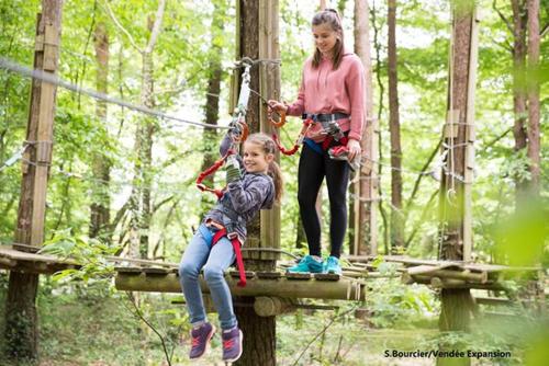 a woman and a child on a suspension bridge at Gîte Le Rivage in Stavelot