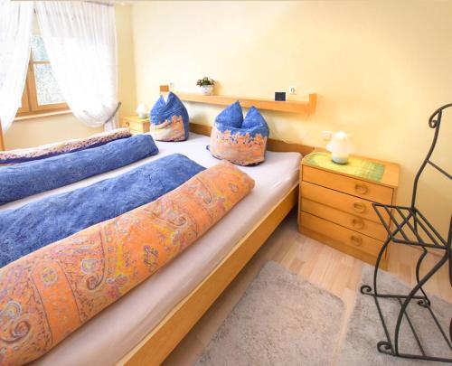 2 camas en un dormitorio con sábanas y almohadas azules en Forsthaus Röthelmoos inkl. Chiemgaukarte, en Ruhpolding