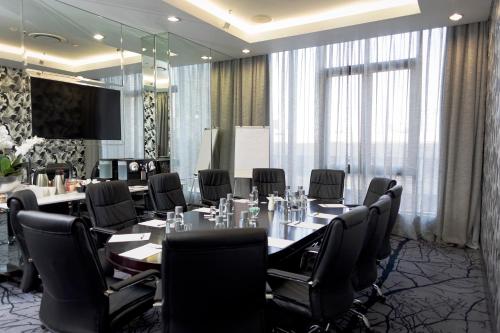 a conference room with a long table and chairs at DAVINCI Suites in Johannesburg