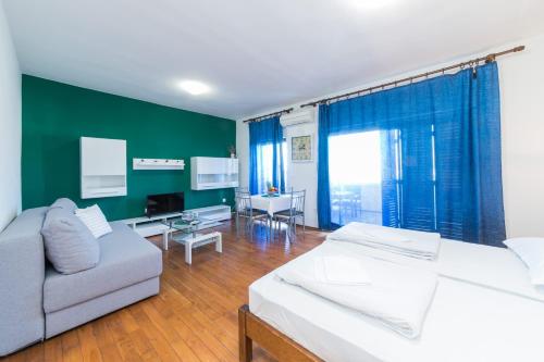 a living room with two beds and a couch at Apartment Green Pag in Pag