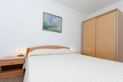 Ένα ή περισσότερα κρεβάτια σε δωμάτιο στο Apartments Puntica
