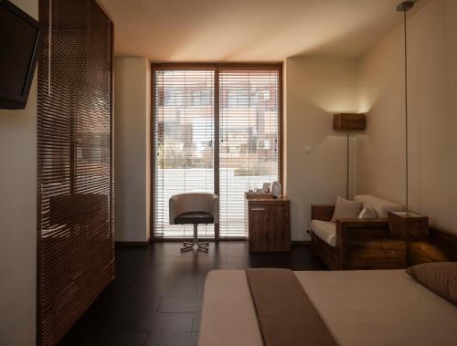 A bed or beds in a room at Design Hotel Logatero