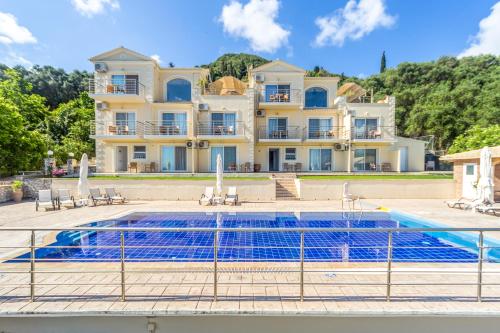 a large house with a swimming pool in front of it at Spileo House Boutique Apartments - Adults Only in Mesongi