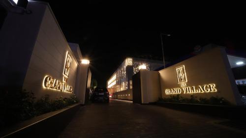 a building with neon signs on it at night at THE GRAND VILLAGE in Morādābād