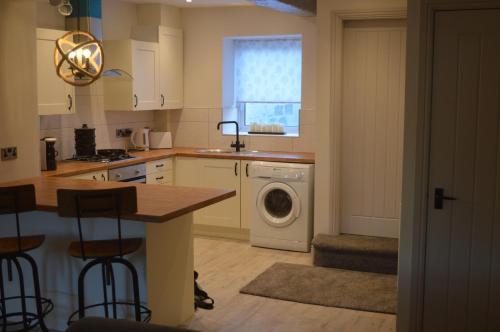 a kitchen with a washing machine and a washer at Foxhill Bank in Oswaldtwistle