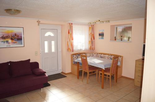 a living room with a table and a couch at Apartment Robert in Maiersdorf
