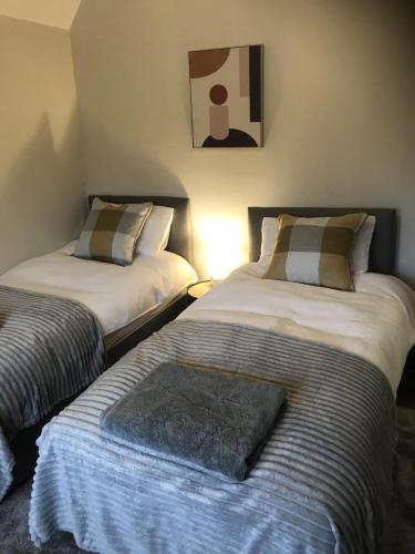 two beds sitting next to each other in a room at North Lodge in Lancaster