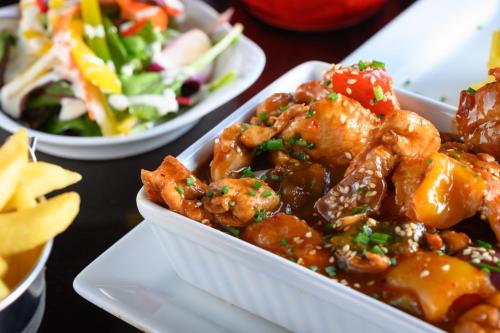a table with three dishes of food and a salad at Rathkeale House Hotel in Limerick