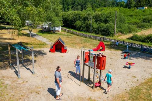 a group of people playing on a playground at Camping du Lac in Marcillac-la-Croisille