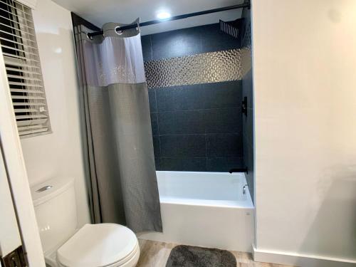 a bathroom with a tub and a toilet and a shower at Endless Summer, North Captiva Island in North Captiva