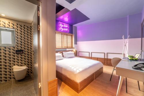 a bedroom with a bed and a desk and a computer at Stay Inn Hotel Jerusalem in Jerusalem