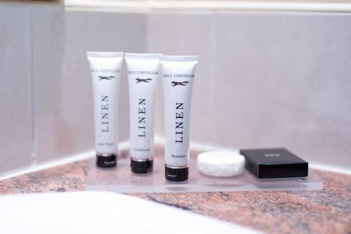 a group of four tubes of toothbrushes on a counter at Tullamore Court Hotel in Tullamore