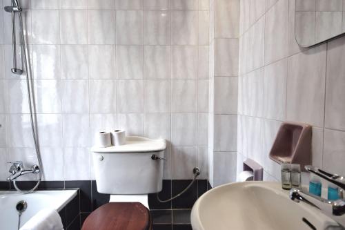 a bathroom with a toilet and a sink and a tub at 2 Bedroom, Central and Spacious Apartment with Sea View - 2 in Msida