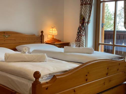 a bedroom with two beds and a window at Bachlaufen Haus in Sesto